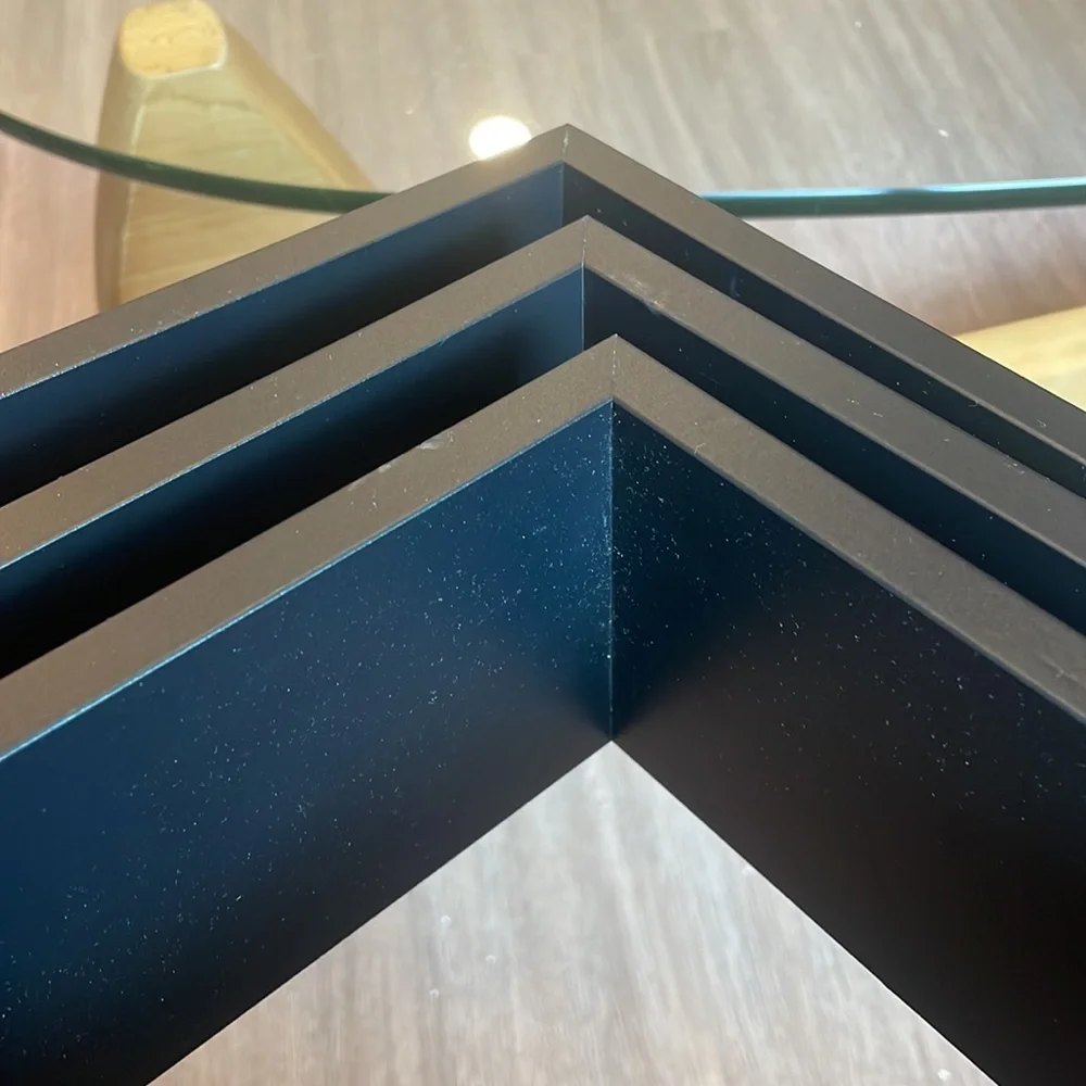 3 black shelving units